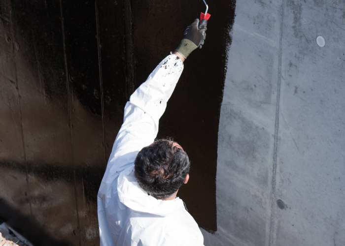 Building professional applying a vertical waterproofing solution on a Subrenat textile for building insulation